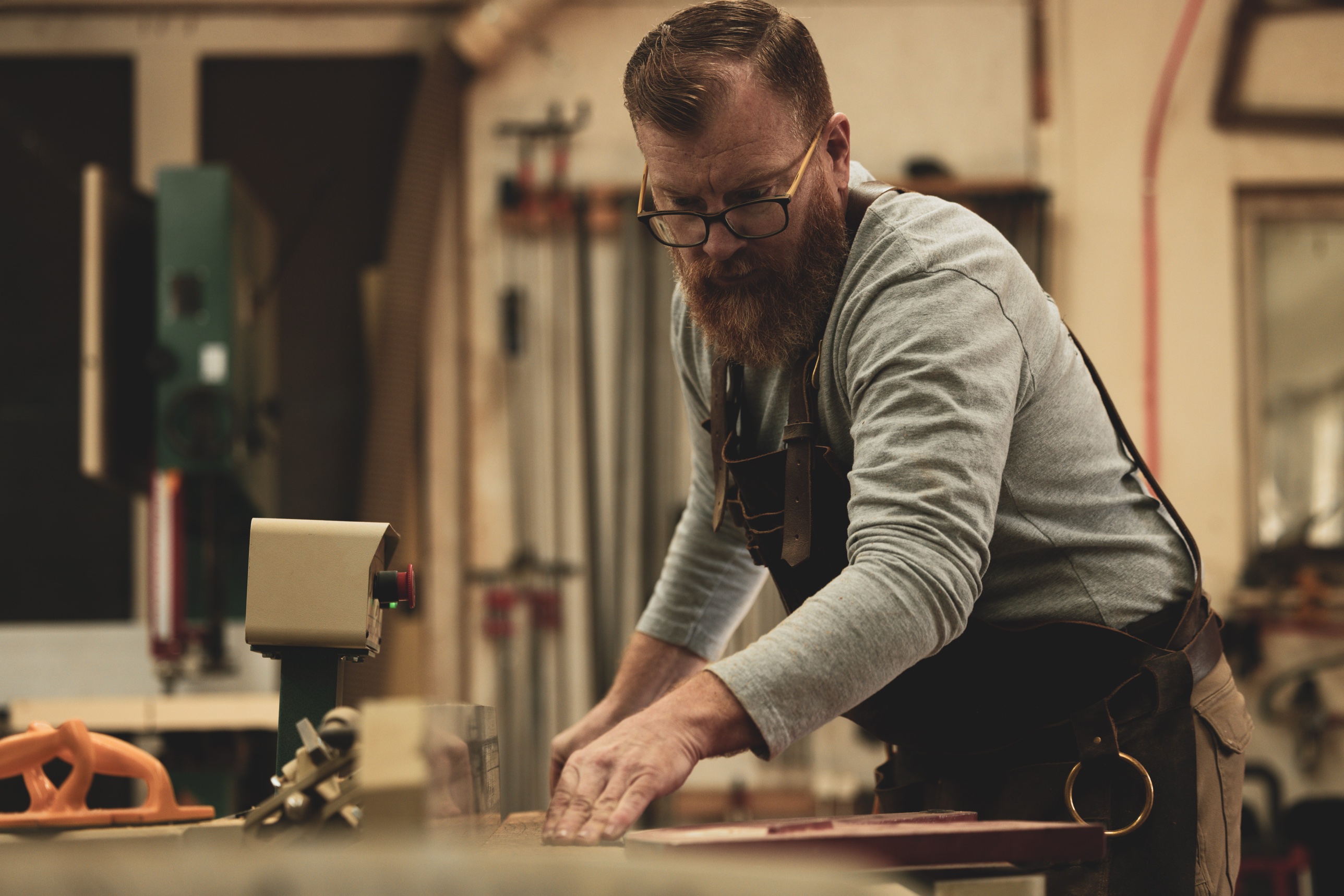 A real shop owner at the bench, mid-job